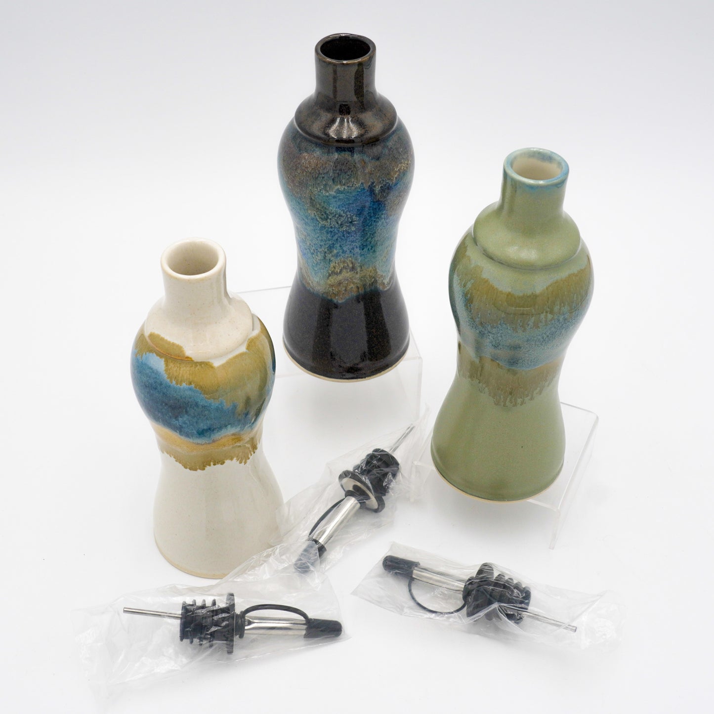 Three ceramic vases with decorative patterns on a white background