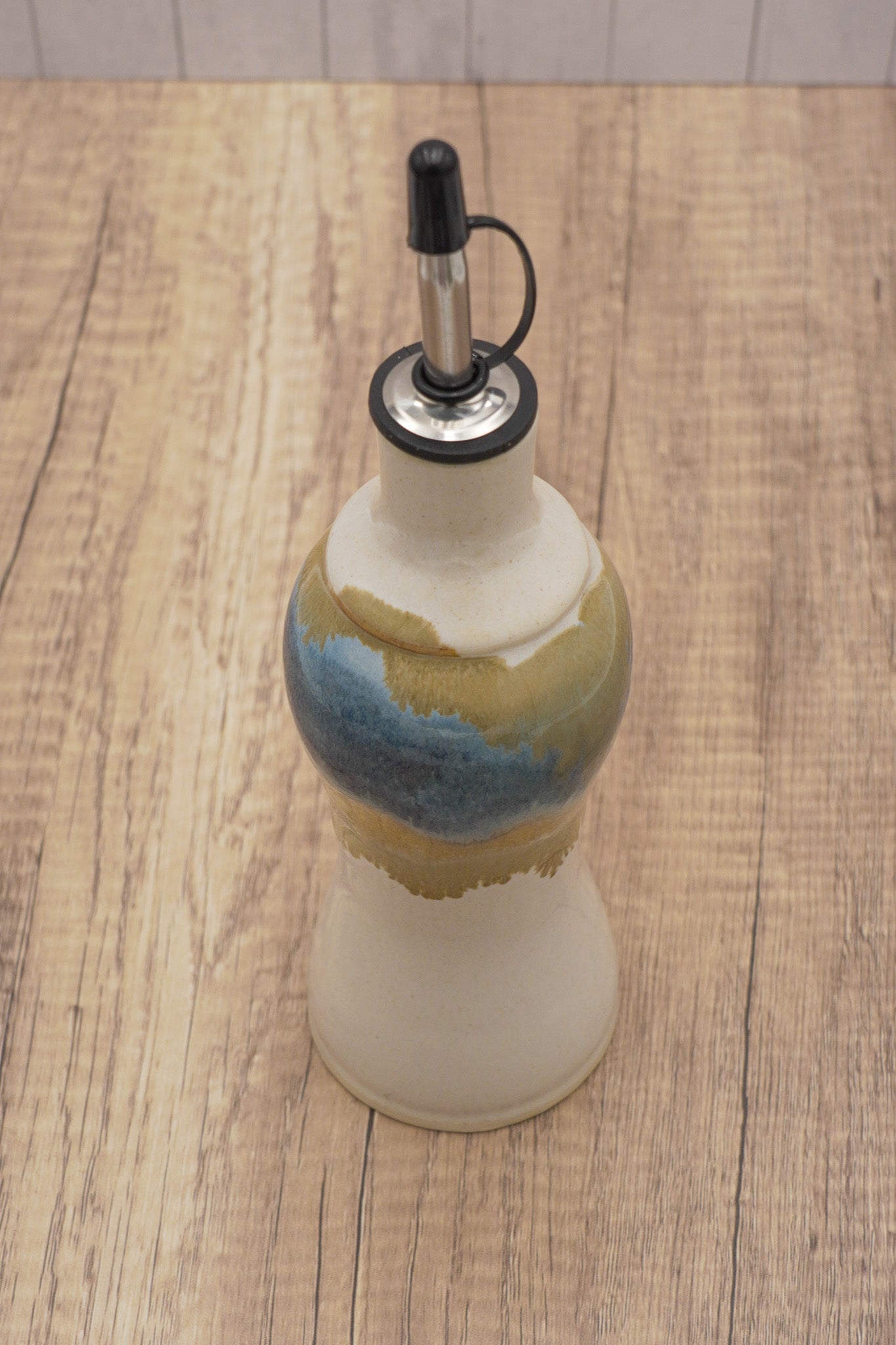 Decorative bottle with a colorful design on a wooden surface